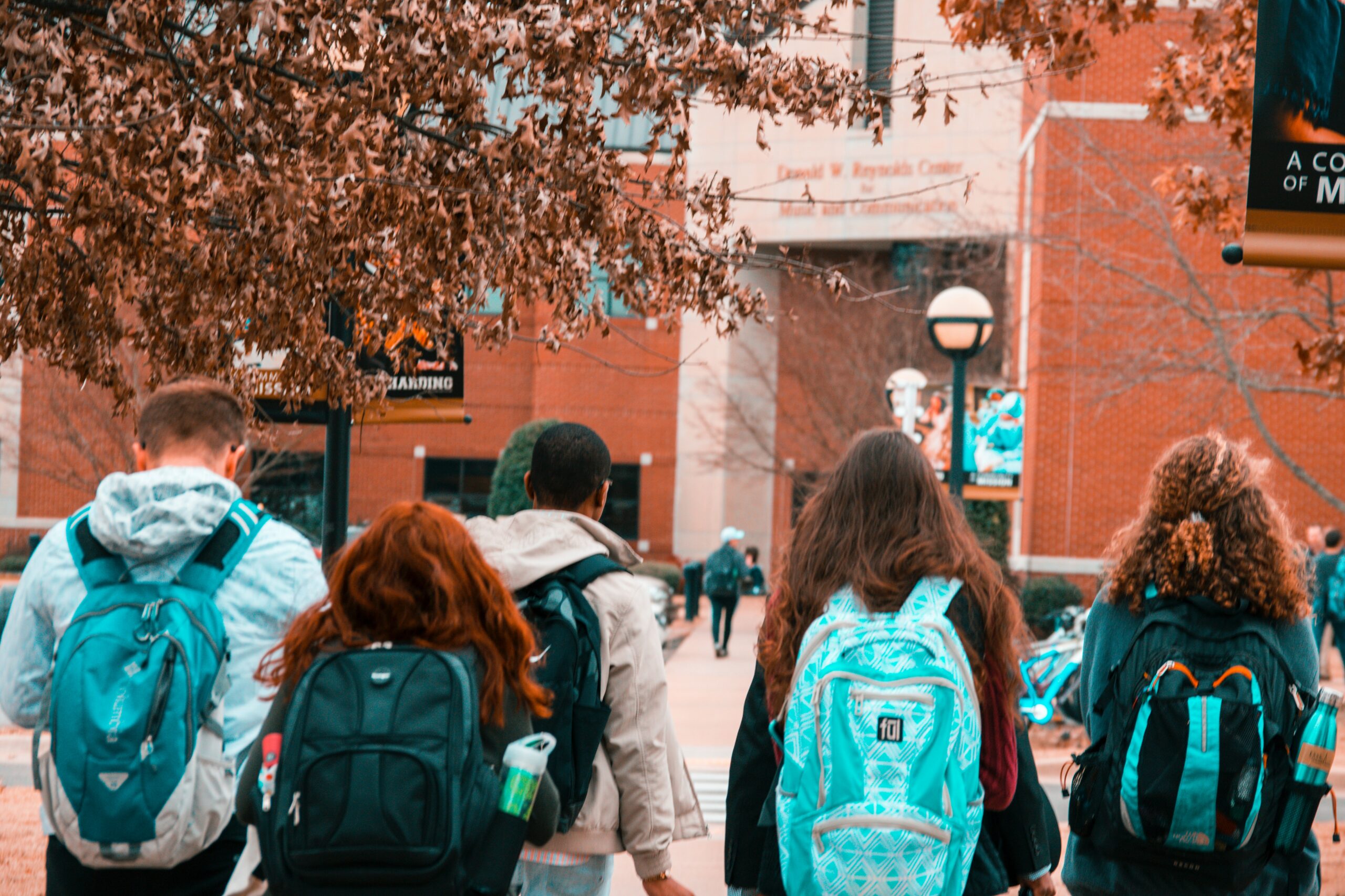 students walking towards a college campus